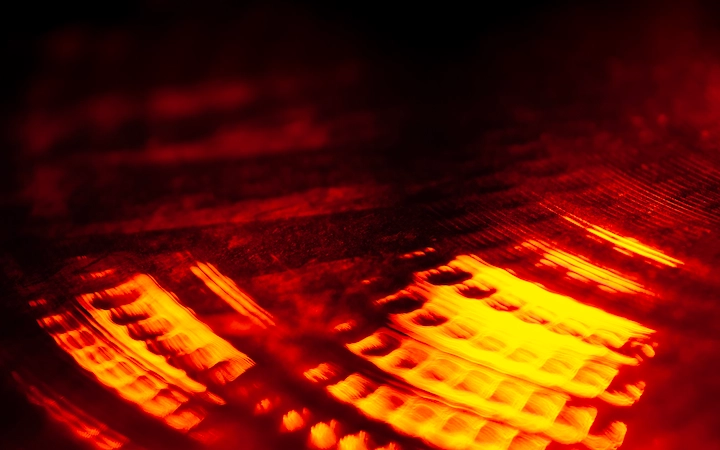 An abstract image of drum cymbal under red lighting.