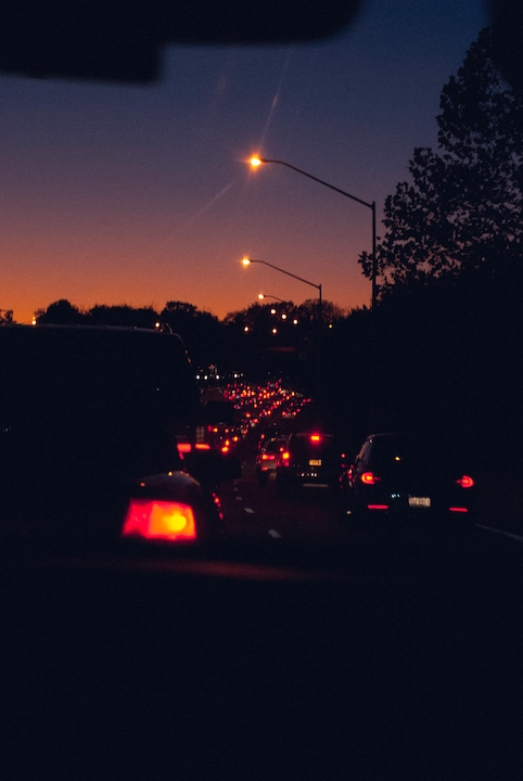 A long traffic jam on the highway with only the tailights of cars visible at night.